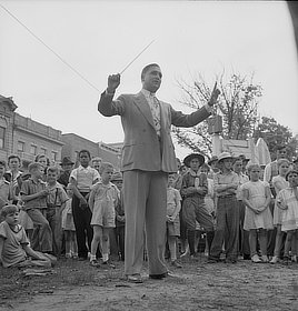 High school teacher leading band at Decoration Day Ceremony, Gallipolis, Ohio. Photo by Arthur Siegel, 1943.