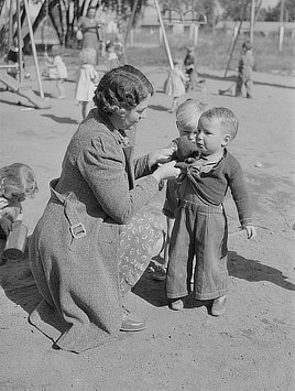 Children and their teacher at the FSA (Farm Security Administration) farm family migratory labor camp. Yakima, Washington. Photo by Russell Lee, 1941.